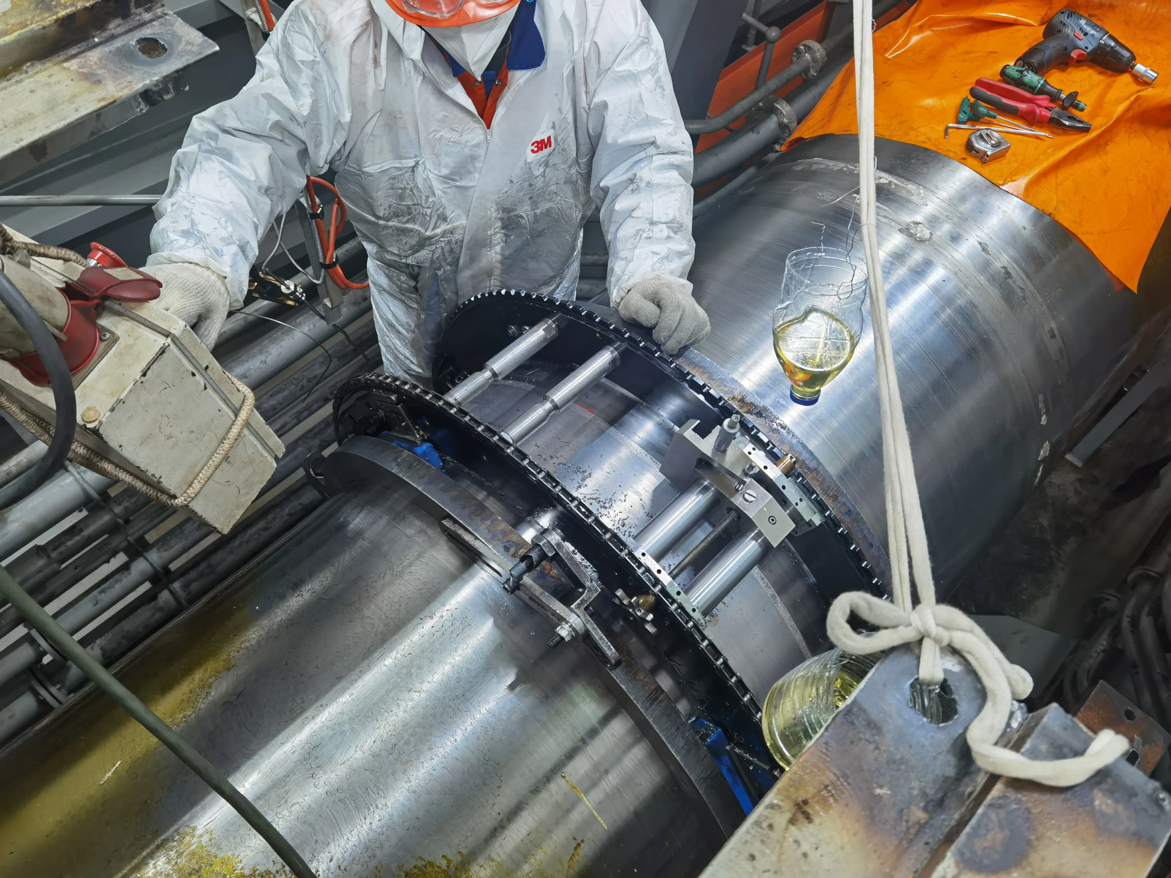 Technician performing in-situ machining on a large marine engine part